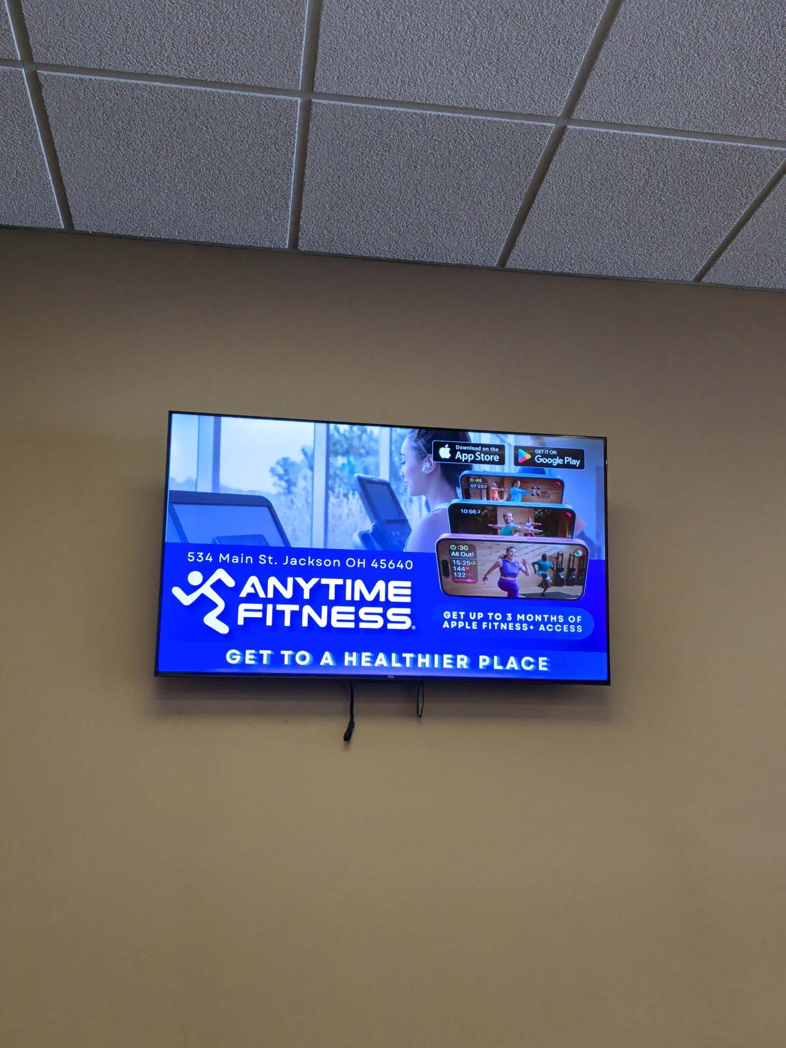 AdSync digital advertising screen installed at Anytime Fitness in Jackson Ohio showing full-screen ad