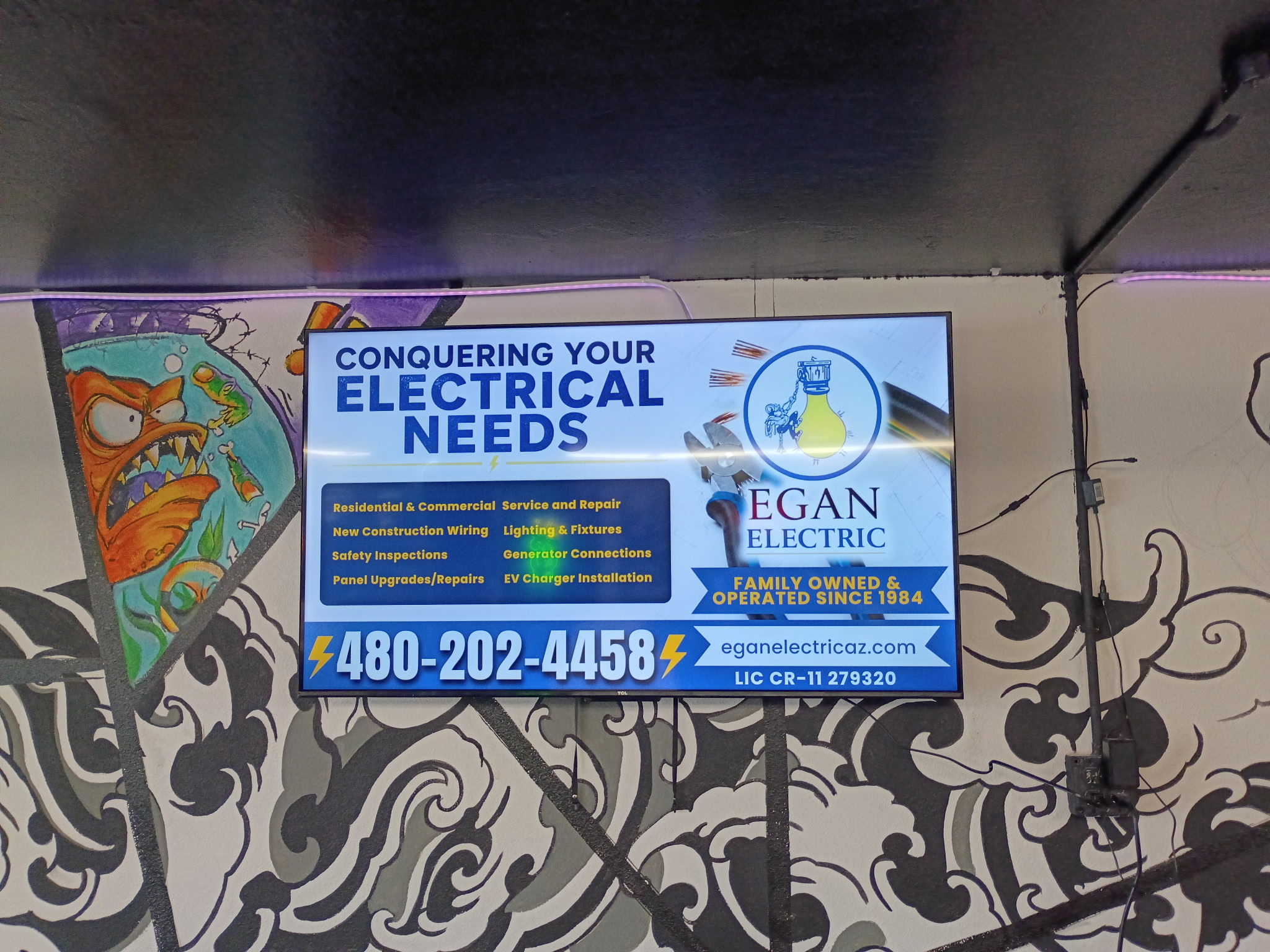 Egan Electric advertisement on AdSync screen inside House of Ink Tattoo Shop in Payson AZ